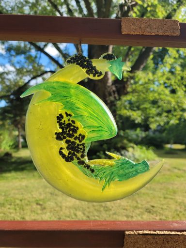 Yellow cresent moon with a green dragon snoozing