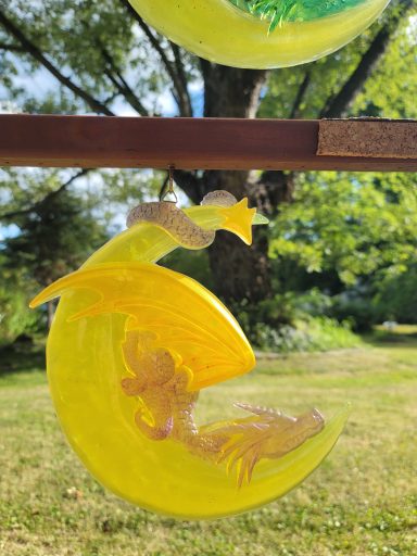 Yellow dragon on a cresent moon snoozing