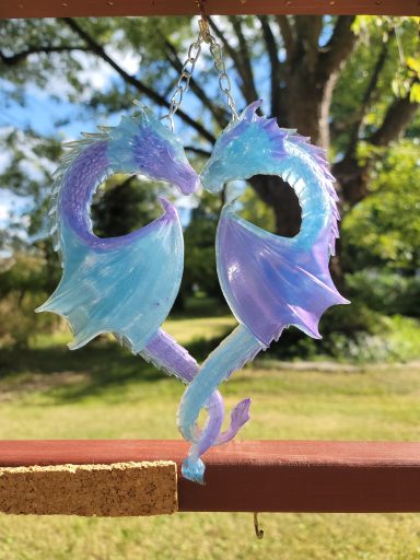 Blue and purple dragons entwined at the tails