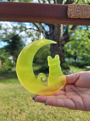 Yellow kitty sitting on a yellow cresent moon