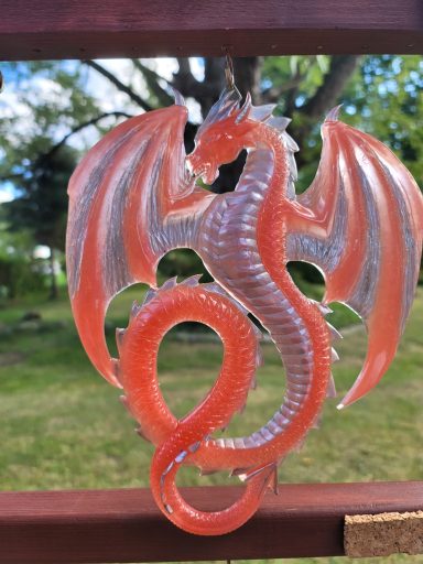 Red dragon with wings outstretched and twising tail