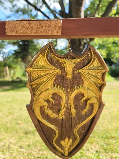 Wooden shield with golden dragons head-to-head