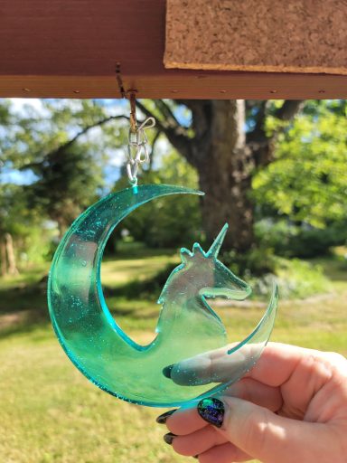 Green unicorn on a green cresent moon